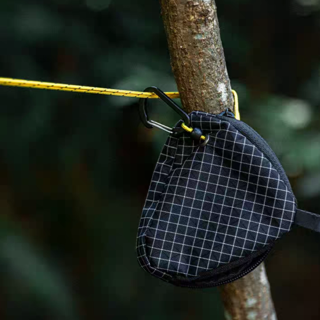 Camping clothesline attached between trees drying clothes outdoors